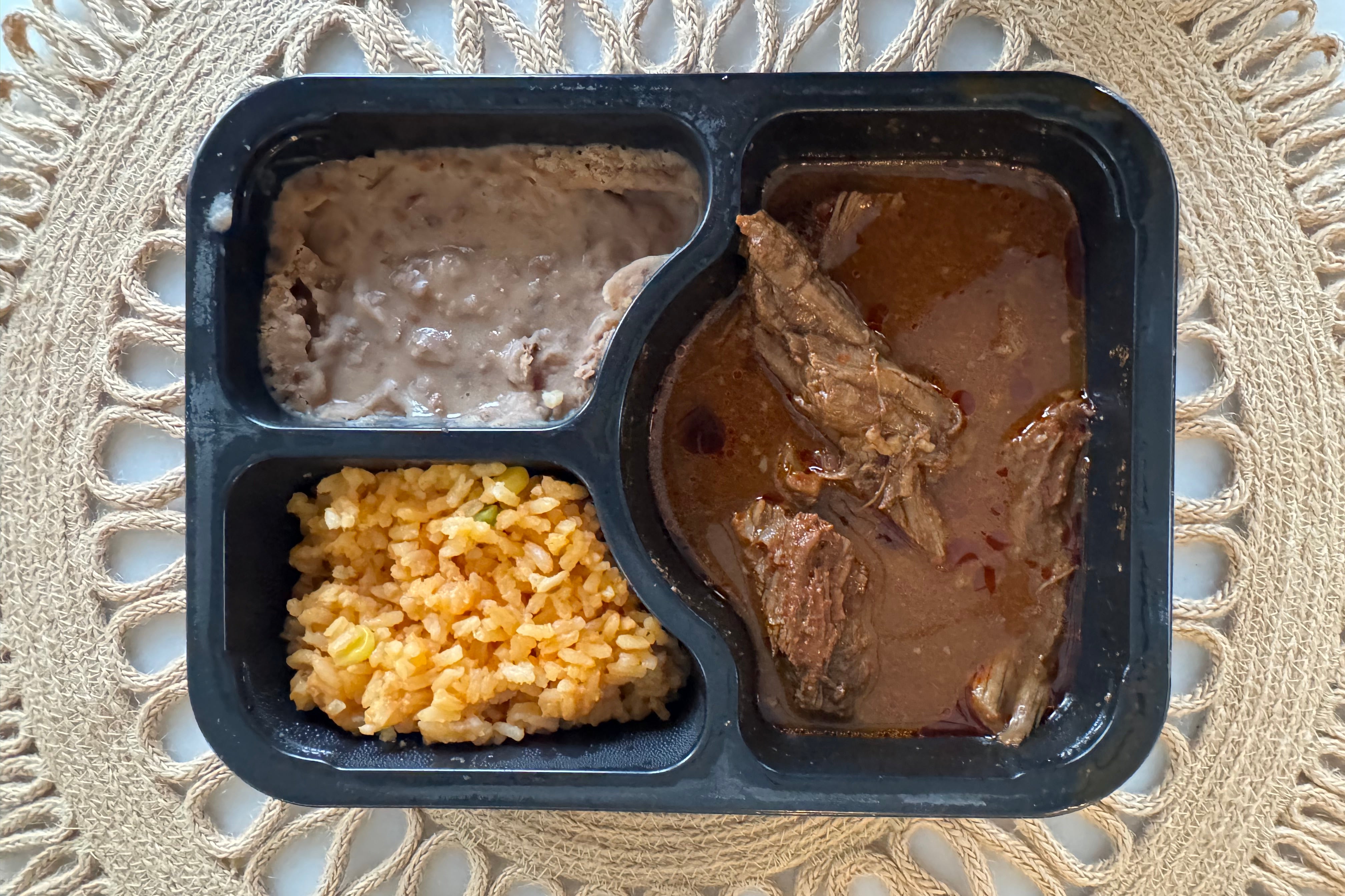 Beef Birria Plate - Beef Birria, red rice, and refried beans.